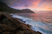 Waves crashing onto the rocks in Hout Bay at sunset. Hout Bay, Cape Town, South Africa. February 2012. Non-ex.