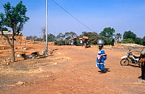 Sevare village scene with villagers carrying goods. Mali, 2005-2006.
