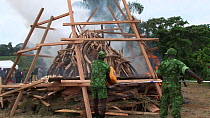 Park rangers burning ivory, with 6 tonnes of African elephant (Loxodonta africana) tusks, Libreville, Gabon, June 6th 2012.