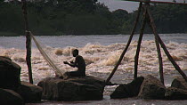 Fisherman mending nets by the Wagena rapids on the Congo River, Kisangani, Democratic  Republic of the Congo, 2009.