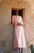 Portrait of village shopkeeper outside building, rural Chad, 2002-2003.