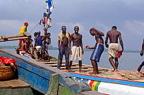 Local cargo and passenger vessel with crew, Port Loko, Sierra Leone, 2004-2005.