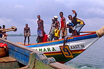 Local cargo and passenger vessel with crew, Port Loko, Sierra Leone, 2004-2005.