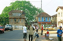 Local people in street scene, buildings typical 19th century colonial architecture, Freetown, Sierra Leone, 2004-2005.