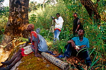 Mountain guides and camera assistant resting on hike to Sankanbiriwa mountain. Sierra Leone, 2004-2005.