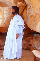 Desert guide standing by rock paintings, central Mauritania, 2004.