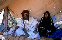 Local guide with his wife wearing traditional clothes, central Mauritania, 2004.