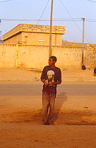 Young man waiting for taxi wearing Osama bin Laden t shirt, Niger, 2003.