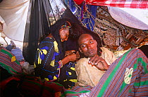 Peul / Fula people under cover at gathering for ritual ceremonies, Agadez region, Niger, 2005.
