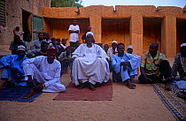 Sultan of Mirriah sitting outside building with sons and courtiers. Niger, 2005.