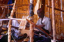 Man weaving traditional Peul / Fula fabric on loom. National Museum, Naiamey, Niger, 2004.