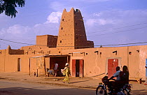 Agadez street scene with people on motorbike, Niger, 2004.