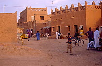 Agadez street scene with local people and cyclist, Niger, 2004.