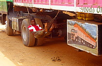 Hired man in hammock looking after truck from Nigeria, Niamey, Niger, 2005.