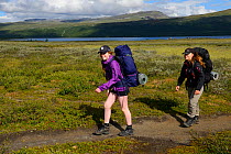 Teenage girls on family hiking trip on the Laponia Circuit, of the Padjelantaleden trail, Padjelanta National Park and Sarek National Park, Norrbotten, Lapland, Sweden. Model released