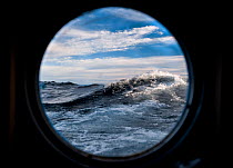 Waves viewed through porthole, Lake Baikal, Pribaikalsky National Park, Siberia, Russia, September 2013. Property released.