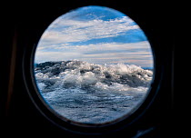 Waves viewed through porthole, Lake Baikal, Pribaikalsky National Park, Siberia, Russia, September 2013.