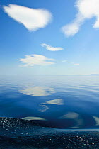 Clouds reflected in surface of Lake Baikal, Siberia, Russia, May 2009.