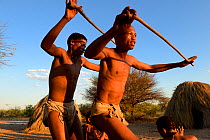 Family of Naro San Bushmen performing traditional dance, Kalahari, Ghanzi region, Botswana, Africa. Dry season, October 2014.