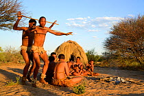 Naro San Bushmen with family performing traditional dance, Kalahari, Ghanzi region, Botswana, Africa. Dry season, October 2014.