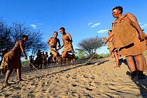 Naro San Bushmen family, women and children playing with skipping rope, Kalahari, Ghanzi region, Botswana, Africa. Dry season, October 2014.