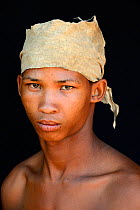 Portrait of Naro San Bushman with leather headdress made of duiker skin, Kalahari, Ghanzi region, Botswana, Africa. October 2014.