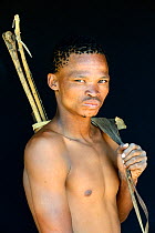 Portrait of Naro San Bushman with bow and arrows, Kalahari, Ghanzi region, Botswana, Africa. October 2014.