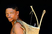 Portrait of Naro San Bushman with bow and arrows, Kalahari, Ghanzi region, Botswana, Africa. October 2014.