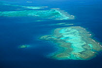 Aerial view of atolls with surrounding coral reefs, off the coast of New Caledonia, September 2008