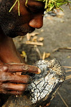 Demonstration of how to make fire from smouldering log, Tanna Island, Tafea Province, Vanuatu, September 2008.