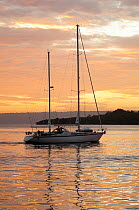 Sail boat at sunset. Port Vila Bay, Efate Island, Vanuatu, September 2008.