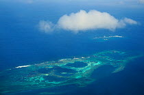 Aerial view of atolls with surrounding coral reefs, off the coast of New Caledonia, September 2008.