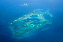 Aerial view of atolls with surrounding coral reefs, off the coast of New Caledonia, September 2008.