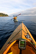 View from kayak as Phil Russell leads the way to fishing grounds along the Strait of Juan De Fuca, Washington, USA, August 2014. Model released.