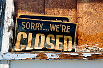 'Closed' sign in boarded up shop window, Sprauge, Washington, USA, June 2014.