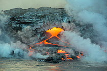 Hot lava from coastal lava tubes of Kilauea volcano entering the ocean, Hawaii Volcanoes National Park, Puna, Hawaii, USA.