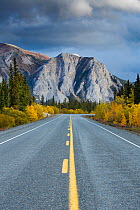 The road to Skagway with autumnal trees and mountain, South Klondike Highway, Yukon Territories, Canada, September 2013.