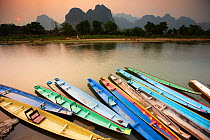 Colourful canoes moored on the Nam Song River at Vang Vieng, Laos, March 2009.
