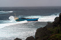 Inter Island container ship, aground and wrecked, Yonaguni Island, East China Sea, Japan. February 2014.