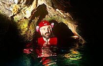 BBC Producer Neil Nightingale in a limestone tunnel, Rock Islands, Palau.