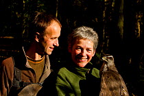 Rose and Lloyd Buck, professional bird handlers and trainers, holding adult female Goshawk (Accipiter gentilis) Somerset, UK, January 2013. Captive, occurs throughout much of the Northern Hemisphere.
