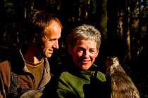 Rose and Lloyd Buck, professional bird handlers and trainers, holding adult female Goshawk (Accipiter gentilis) Somerset, UK, January 2013. Captive, occurs throughout much of the Northern Hemisphere.