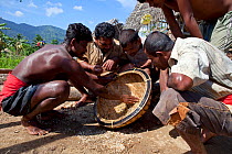 Miners sorting gravel while panning for gemstones, Ratnapura, Sri Lanka, December 2012.