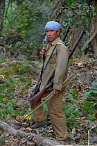 Portrait of armed ranger, Kaziranga National Park, Assam, India, March 2014.