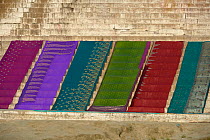 Wet saris drying on steps on the banks of the Ganges, Varanasi, Uttah Pradesh, India, March 2014.