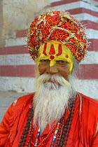 Portrait of priest with painted face wearing turban, Varanasi, Uttah Pradesh, India, March 2014l.