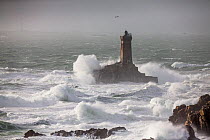 Waves lashing La Vieille ('The Old Lady') Lighthouse during winter storm, Plogoff, Finistere, Brittany, France.