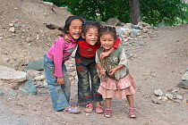 Group of local children smiling, near Lantsang Mekong river, Kawakarpo Mountain, Meri Snow Mountain National Park, Yunnan Province, China.