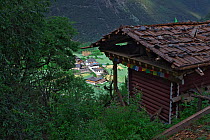 Building with traditional architecture and prayer flags Kawakarpo Mountain, Meri Snow Mountain National Park, Yunnan Province, China.