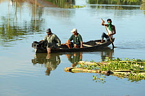 Photographer Sandesh Kadur filming the floods on a raft. Kaziranga National Park, India. June 2012.